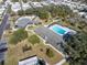 Aerial view of community clubhouse and pool featuring mature landscaping, walking paths and ample parking at 9790 66Th N St # 469, Pinellas Park, FL 33782