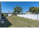 Wide green backyard with white fence and exterior of the home at 9790 66Th N St # 469, Pinellas Park, FL 33782