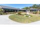 Beautiful clubhouse exterior with lush landscaping, offering a welcoming entrance at 9790 66Th N St # 469, Pinellas Park, FL 33782