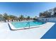 Spacious community pool area with ample seating and a separate pool house at 9790 66Th N St # 469, Pinellas Park, FL 33782