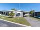 Charming single-story home featuring a carport, well-maintained landscaping, and a cozy facade at 9790 66Th N St # 469, Pinellas Park, FL 33782