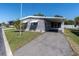 Exterior of home with awning over the windows and front yard at 9790 66Th N St # 469, Pinellas Park, FL 33782