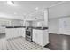 Open kitchen featuring stainless steel appliances, white cabinets, and unique black and white patterned flooring at 9790 66Th N St # 469, Pinellas Park, FL 33782
