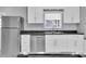Well-lit kitchen with stainless steel refrigerator, dishwasher, sink, and white cabinets with dark countertops at 9790 66Th N St # 469, Pinellas Park, FL 33782