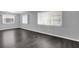 Spacious living room with new flooring, fresh paint, and large windows providing natural light at 9790 66Th N St # 469, Pinellas Park, FL 33782