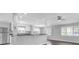 Open-concept living area with a kitchen bar and stainless steel appliances at 9790 66Th N St # 469, Pinellas Park, FL 33782