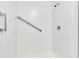 All-white shower featuring a chrome grab bar and shower head for convenience and safety at 9790 66Th N St # 469, Pinellas Park, FL 33782