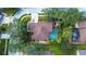 Aerial view of a private backyard oasis with a sparkling pool, lush landscaping and mature trees at 10130 Paddock Oaks Dr, Riverview, FL 33569
