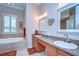 Bright main bathroom with double sinks and separate tub at 10130 Paddock Oaks Dr, Riverview, FL 33569