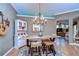 Cozy dining area with stylish light fixture, adjacent to an open archway leading to the living room at 10130 Paddock Oaks Dr, Riverview, FL 33569