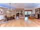 Open-concept dining room featuring wood floors, elegant lighting, and seamless flow to other living spaces at 10130 Paddock Oaks Dr, Riverview, FL 33569