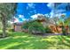 Charming home with a well-manicured lawn, lush landscaping, and a privacy fence at 10130 Paddock Oaks Dr, Riverview, FL 33569