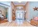 Elegant foyer with a decorative glass transom, double doors, tile flooring, and stylish furnishings at 10130 Paddock Oaks Dr, Riverview, FL 33569