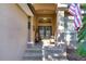 Inviting front entrance with a decorative glass door, patriotic decor, and tiled steps leading to the home at 10130 Paddock Oaks Dr, Riverview, FL 33569