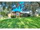 Well-manicured front lawn with beautiful landscaping and mature trees enhancing the curb appeal of this home at 10130 Paddock Oaks Dr, Riverview, FL 33569