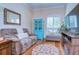 Cozy sitting room featuring a comfortable recliner, a bright window, and tasteful decor at 10130 Paddock Oaks Dr, Riverview, FL 33569