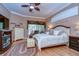 Relaxing main bedroom with ceiling fan and ensuite bath at 10130 Paddock Oaks Dr, Riverview, FL 33569