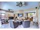 Screened patio with comfortable seating and an outdoor television for entertaining at 10130 Paddock Oaks Dr, Riverview, FL 33569