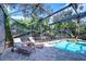 Relaxing screened-in pool area with comfortable lounge chairs and ample space to enjoy the outdoors at 10130 Paddock Oaks Dr, Riverview, FL 33569
