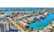 Stunning aerial view of waterfront condos, boats, and city skyline offering beautiful coastal living at 113 Island Way # 241, Clearwater Beach, FL 33767