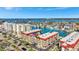 Stunning aerial view showcasing the complex with waterfront access, surrounded by beautiful blue water and clear skies at 113 Island Way # 241, Clearwater Beach, FL 33767