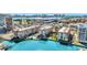 Aerial view showcases the condo community, pool, waterfront access, and the beautiful city skyline in the background at 113 Island Way # 241, Clearwater Beach, FL 33767