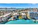 Aerial view of condo buildings, docks, pool, landscaped grounds, and city skyline at 113 Island Way # 241, Clearwater Beach, FL 33767