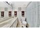 This bathroom features a long vanity, toilet and shower curtain at 113 Island Way # 241, Clearwater Beach, FL 33767