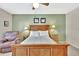 This bedroom features carpet, a ceiling fan, and a green accent wall at 113 Island Way # 241, Clearwater Beach, FL 33767