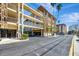 Exterior view of the condo building featuring private balconies and well-maintained landscaping at 113 Island Way # 241, Clearwater Beach, FL 33767