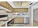 Efficient kitchen with white appliances, bright countertops, and updated cabinetry at 113 Island Way # 241, Clearwater Beach, FL 33767
