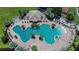 Aerial view of the community pool area with lounge chairs and palm trees at 11539 Captiva Kay Dr, Riverview, FL 33569
