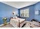 Blue bedroom with laminate floors, wood frame bed, desk and ocean-themed decor at 11539 Captiva Kay Dr, Riverview, FL 33569