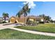 Charming single-story home with a two-car garage, well-maintained landscaping, and mature palm trees at 11539 Captiva Kay Dr, Riverview, FL 33569