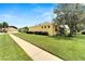 Well-maintained home exterior with lush lawn and mature trees on a sunny day at 11539 Captiva Kay Dr, Riverview, FL 33569