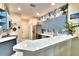 Eat-in kitchen offers stainless appliances, white countertops, blue cabinets and a breakfast bar at 11539 Captiva Kay Dr, Riverview, FL 33569