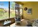 Enclosed lanai featuring bright yellow walls, comfortable chair and side table at 11539 Captiva Kay Dr, Riverview, FL 33569
