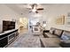 Open-concept living area with modern furniture, a ceiling fan, and seamless flow to the dining area at 11539 Captiva Kay Dr, Riverview, FL 33569