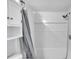 Bright bathroom features a white shower/tub combo with a gray shower curtain at 12135 Environmental Dr # 2, New Port Richey, FL 34654