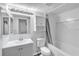 Clean and bright bathroom with a neutral color palette, vanity, mirror, and tub/shower combination at 12135 Environmental Dr # 2, New Port Richey, FL 34654