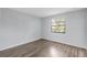 Well-lit bedroom showcasing vinyl flooring and a window with sun-filtering blinds at 12135 Environmental Dr # 2, New Port Richey, FL 34654