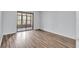 Cozy bedroom with wood flooring and sliding glass doors leading to an outdoor patio at 12135 Environmental Dr # 2, New Port Richey, FL 34654