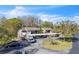 Exterior aerial showcasing the condo, surrounded by mature trees, with a parking area available to residents at 12135 Environmental Dr # 2, New Port Richey, FL 34654