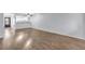 Open floor plan with wood flooring throughout the living room, dining area, and kitchen at 12135 Environmental Dr # 2, New Port Richey, FL 34654