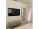 This bedroom features a TV and cushioned bench at 125 5Th Ne Ave # 240, St Petersburg, FL 33701