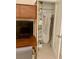 A desk with closet featuring shelves, clothing rods, and ironing board at 125 5Th Ne Ave # 240, St Petersburg, FL 33701