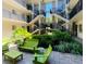 Inviting courtyard with green furniture and lush landscaping, perfect for relaxation at 125 5Th Ne Ave # 240, St Petersburg, FL 33701