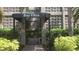 Close-up of the Bay Villas entrance with decorative breeze block walls and lush tropical landscaping at 125 5Th Ne Ave # 240, St Petersburg, FL 33701