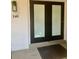 Exterior view of the home's front door, adorned with a modern light fixture and house number 240 at 125 5Th Ne Ave # 240, St Petersburg, FL 33701
