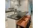 Beautiful kitchen with black countertops, white cabinets, subway tile, stainless steel appliances and barstool seating at 125 5Th Ne Ave # 240, St Petersburg, FL 33701